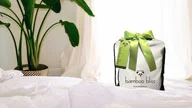 <h1>Bamboo Bliss Packaging Design</h1> Next we designed and developed a complete retail packaging solution for each individual product with the goal of developing creative cost effective packaging for sheet sets and duvet cover sets that could be reused and repurposed by the consumer. Here we incorporated the Bamboo Bliss signature apple green ribbon and product tag to elicit the eco-luxury aspects of Bamboo Bliss bedding.